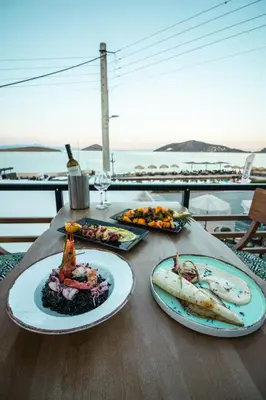 a table with three plates of food on it at Kiani Akti in Porto Rafti