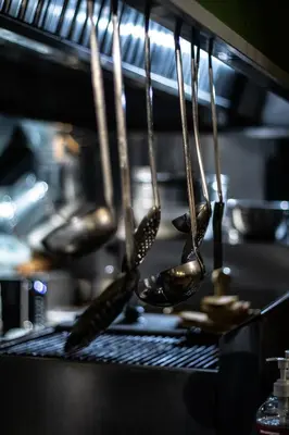 a group of utensils hanging from a rack in a kitchen at Kiani Akti in Porto Rafti