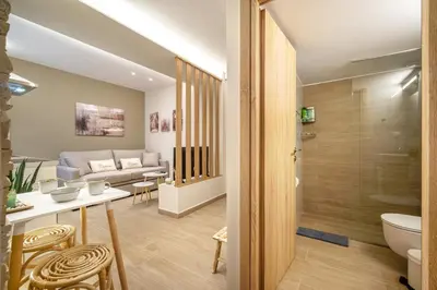 a living room with a couch and a bathroom at Athens Lodge in Koukaki in Athens