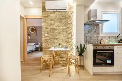 a kitchen and dining room with a brick wall at Athens Lodge in Koukaki in Athens