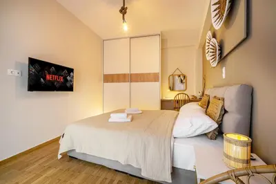 a bedroom with a bed and a tv on the wall at Athens Lodge in Koukaki in Athens