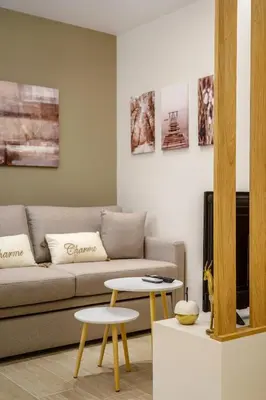 a living room with a couch and two tables at Athens Lodge in Koukaki in Athens