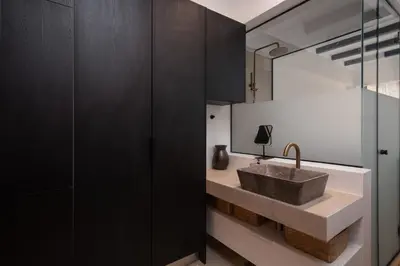 a bathroom with a sink and a mirror at 1BR Backyard Jacuzzi Retreat Near Acropolis in Athens