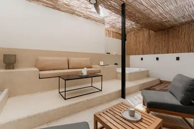 a living room with a couch and a tub at 1BR Backyard Jacuzzi Retreat Near Acropolis in Athens