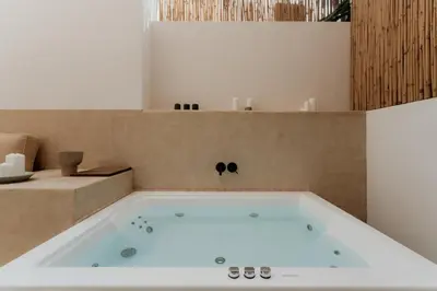 a bath tub in a bathroom with at 1BR Backyard Jacuzzi Retreat Near Acropolis in Athens