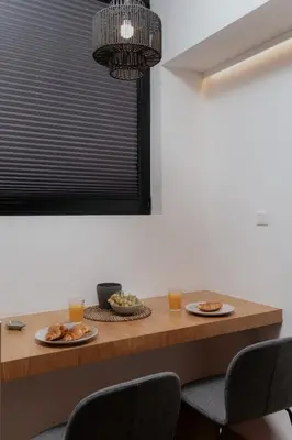 a dining room table with two plates of food on it at 1BR Backyard Jacuzzi Retreat Near Acropolis in Athens