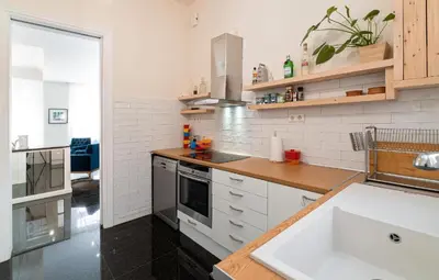 a white kitchen with a sink and a stove at Spacious & Artistic Retro 2BD Apt with SAUNA in Athens