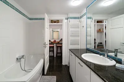 a white bathroom with a tub and a sink at Spacious & Artistic Retro 2BD Apt with SAUNA in Athens
