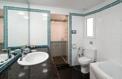 a bathroom with a sink and a toilet and a tub at Spacious & Artistic Retro 2BD Apt with SAUNA in Athens