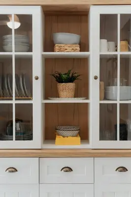 a white cabinet with glass doors with dishes at Elegant 2BR Apt Near Acropolis & Metro in Athens
