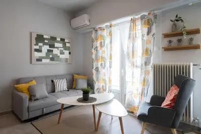 a living room with a couch and a table at Elegant 2BR Apt Near Acropolis & Metro in Athens