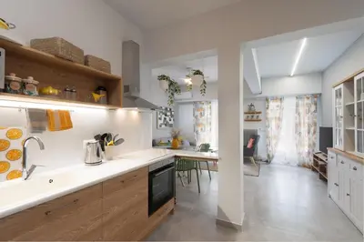 a kitchen with white countertops and a dining room at Elegant 2BR Apt Near Acropolis & Metro in Athens