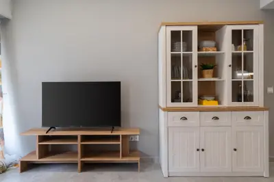 a tv on a stand in a living room at Elegant 2BR Apt Near Acropolis & Metro in Athens