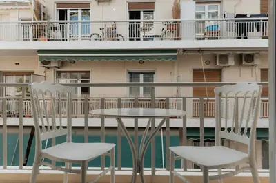 two chairs and a table on a balcony at Elegant 2BR Apt Near Acropolis & Metro in Athens