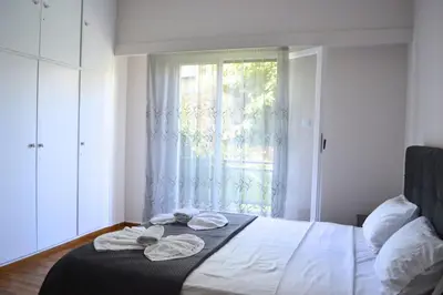 a bedroom with a bed with towels on it at Alice's Apartment - Athens, Ελλάδα in Athens