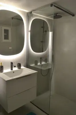 a bathroom with a sink and a shower with a mirror at Alice's Apartment - Athens, Ελλάδα in Athens