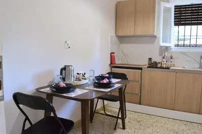 a small kitchen with a table and chairs in it at Alice's Apartment - Athens, Ελλάδα in Athens