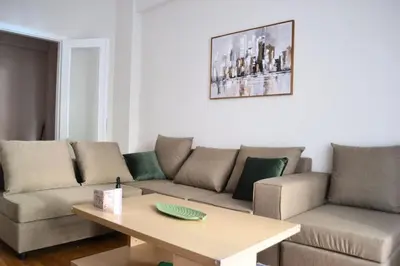 a living room with a couch and a table at Alice's Apartment - Athens, Ελλάδα in Athens