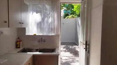 a kitchen with a sink and a window at Kallithea Athens Star in Athens