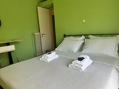 a bedroom with a bed with towels on it at Urban Acropolis Apartment With Fast internet in Athens