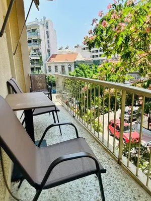 a balcony with tables and chairs and a view of a city at Urban Acropolis Apartment With Fast internet in Athens