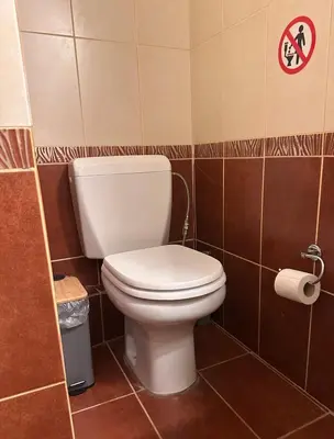 a bathroom with a white toilet in a tiled room at Urban Acropolis Apartment With Fast internet in Athens