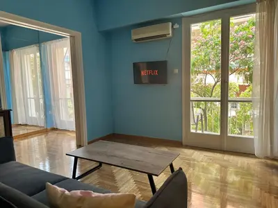 a living room with a couch and a table at Urban Acropolis Apartment With Fast internet in Athens