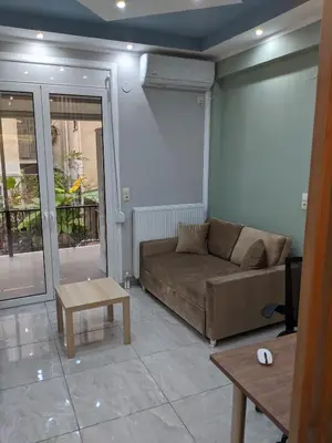 a living room with a couch and a table at Athens Kallithea Apartment in Athens