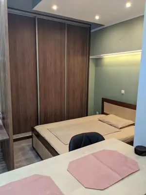 a bedroom with two beds and a closet at Athens Kallithea Apartment in Athens