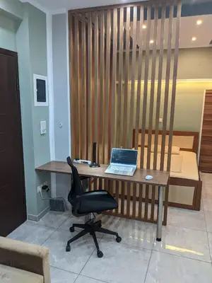 a desk with a laptop on it with a chair at Athens Kallithea Apartment in Athens