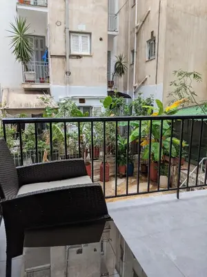 a balcony with a bench and some plants at Athens Kallithea Apartment in Athens