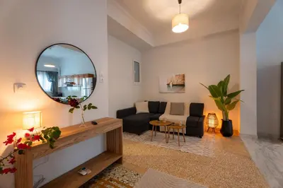 a living room with a mirror and a couch at 1400ft Central Rooftop Gym King Bed WFH in Athens