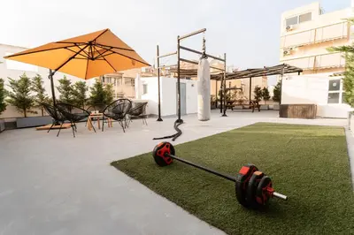 a garden with a exercise equipment on the grass at 1400ft Central Rooftop Gym King Bed WFH in Athens