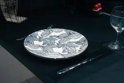 a plate sitting on top of a table with a glass at CityLife apartment 2'from metaxourgio station 2B in Athens