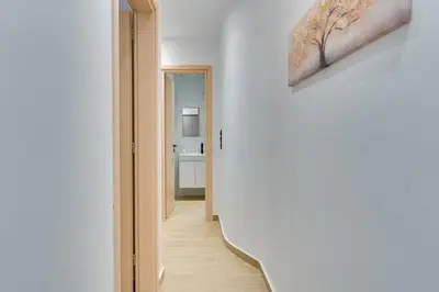 a hallway leading to a room with a bathroom at CityLife apartment 2'from metaxourgio station 2B in Athens