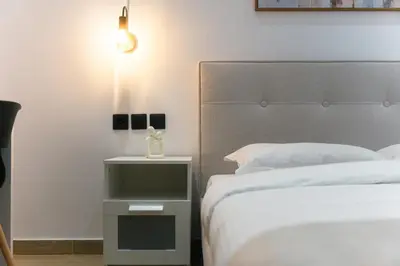 a bedroom with two beds and a nightstand next to a bed at CityLife apartment 2'from metaxourgio station 2B in Athens