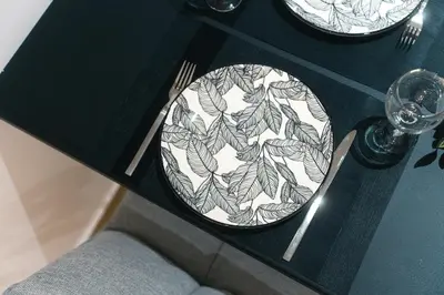 a black and white plate on a table at CityLife studio 2'from metaxourgio station 2A in Mesochórion