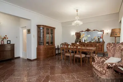 a living room with a table and a dining room at PS Apartment in Athens