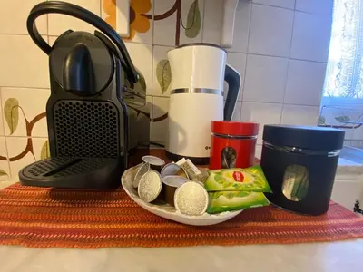 a kitchen counter with a counter top with a blender and a plate of food at PS Apartment in Athens