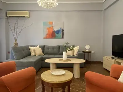 a living room with a couch and a table at PS Apartment in Athens