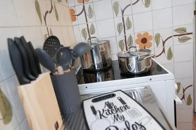 a kitchen with a stove with utensils on it at PS Apartment in Athens