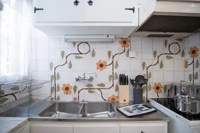 a kitchen with a sink and flowers on the wall at PS Apartment in Athens