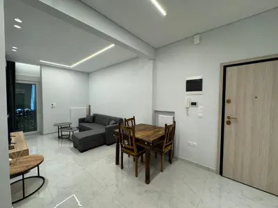 a living room with a table and a couch at D&L Home in Mesochórion