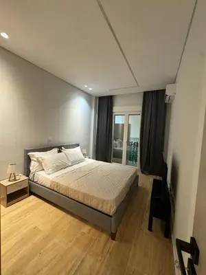 a bedroom with a large bed and a window at D&L Home in Mesochórion