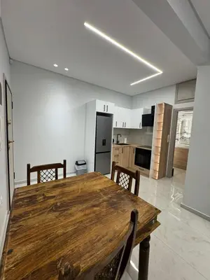 a kitchen with a wooden table and chairs at D&L Home in Mesochórion