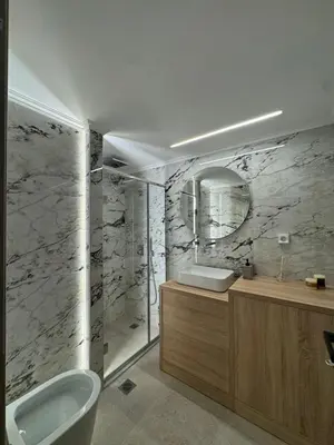 a bathroom with a toilet and a sink and a mirror at D&L Home in Mesochórion