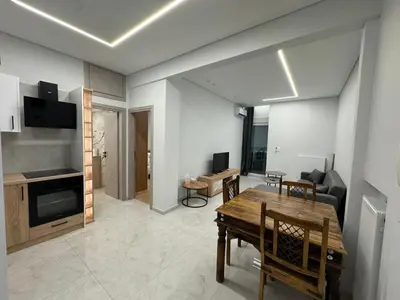 a living room with a table and a dining room at D&L Home in Mesochórion