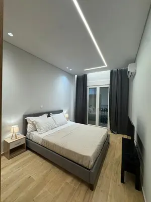 a bedroom with a large bed and a window at D&L Home in Mesochórion