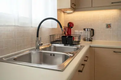 a stainless steel kitchen sink in a kitchen at Sunlit Terrace 3BR Apartment - Tavros by ΜΡS in Athens