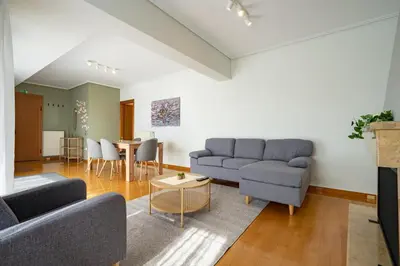a living room with two couches and a table at Sunlit Terrace 3BR Apartment - Tavros by ΜΡS in Athens